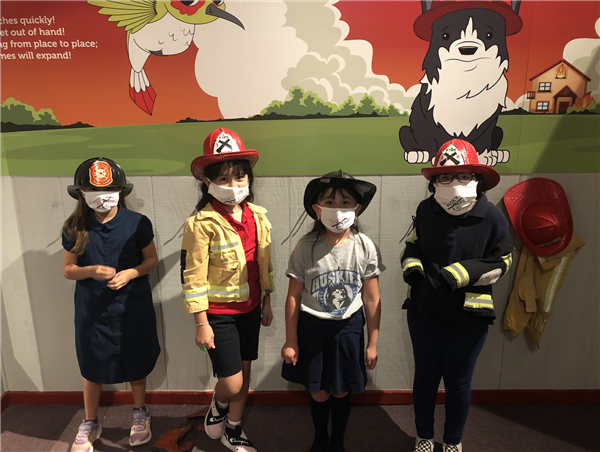 2nd grade students dressed up as firefighters at the Hall of Flame